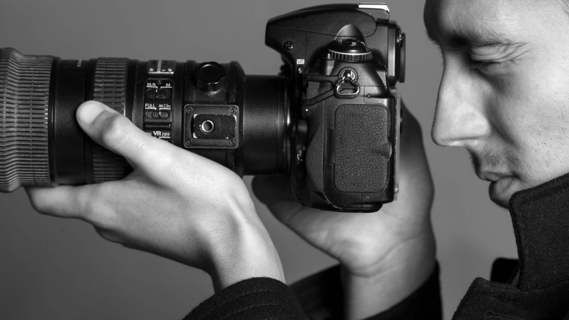 Professional photographer using a high-quality camera to capture images, illustrating the importance of professional photography in real estate marketing for showcasing properties effectively.