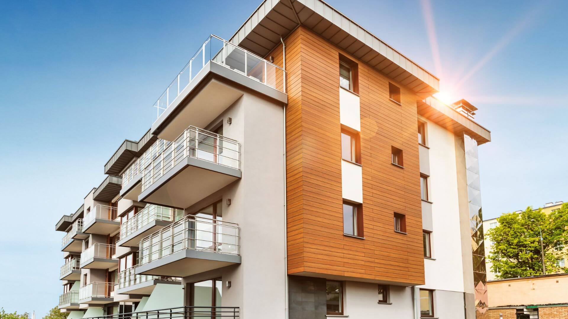 A modern multi-story residential building showcasing contemporary property development trends, featuring sleek balconies and sustainable architectural design.