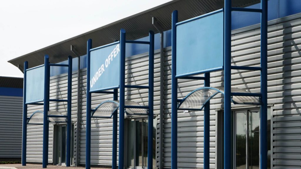 Commercial property building with “Under Offer” signage, representing demand and opportunity when investing in commercial property.