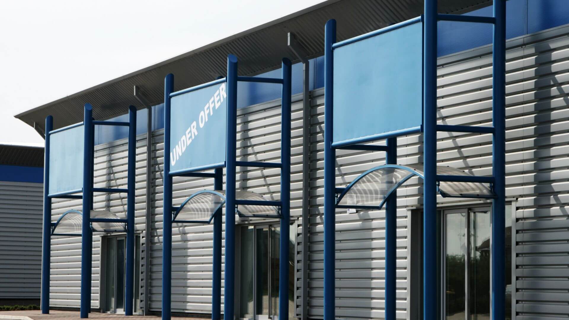Commercial property building with “Under Offer” signage, representing demand and opportunity when investing in commercial property.