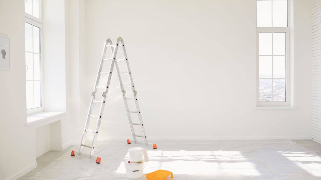A bright, modern room mid-renovation with a ladder, paint buckets and tools, representing current renovation trends
 in Australian investment properties.